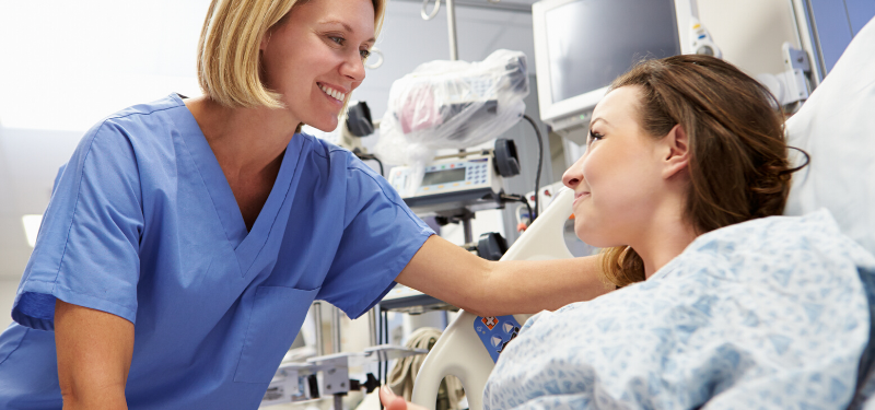 Blonde Nurse at Bedside of Patient