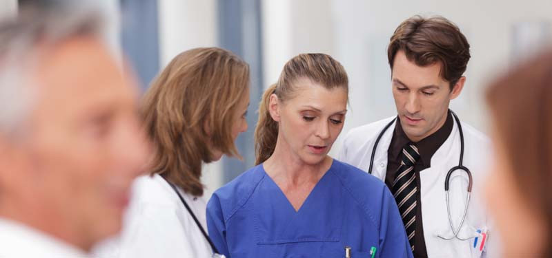 Concerned Nurses Looking at Clipboard