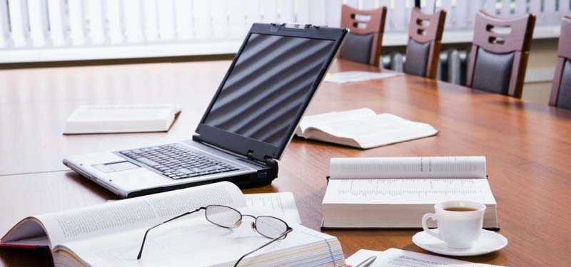 Open Laptop on a Desk with Glasses